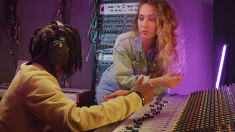 Man-and-Woman-Having-Discussion-in-Recording-Studio