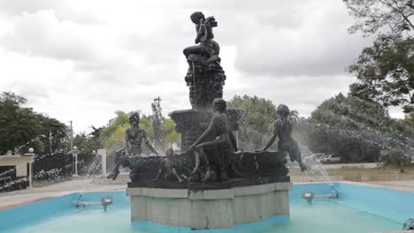 wide view of fountain with ornate statues in park in dominican republic