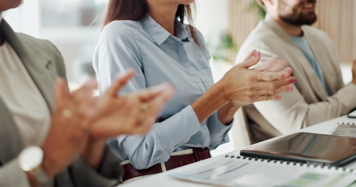 Business Professionals Applauding During a Corporate Meeting