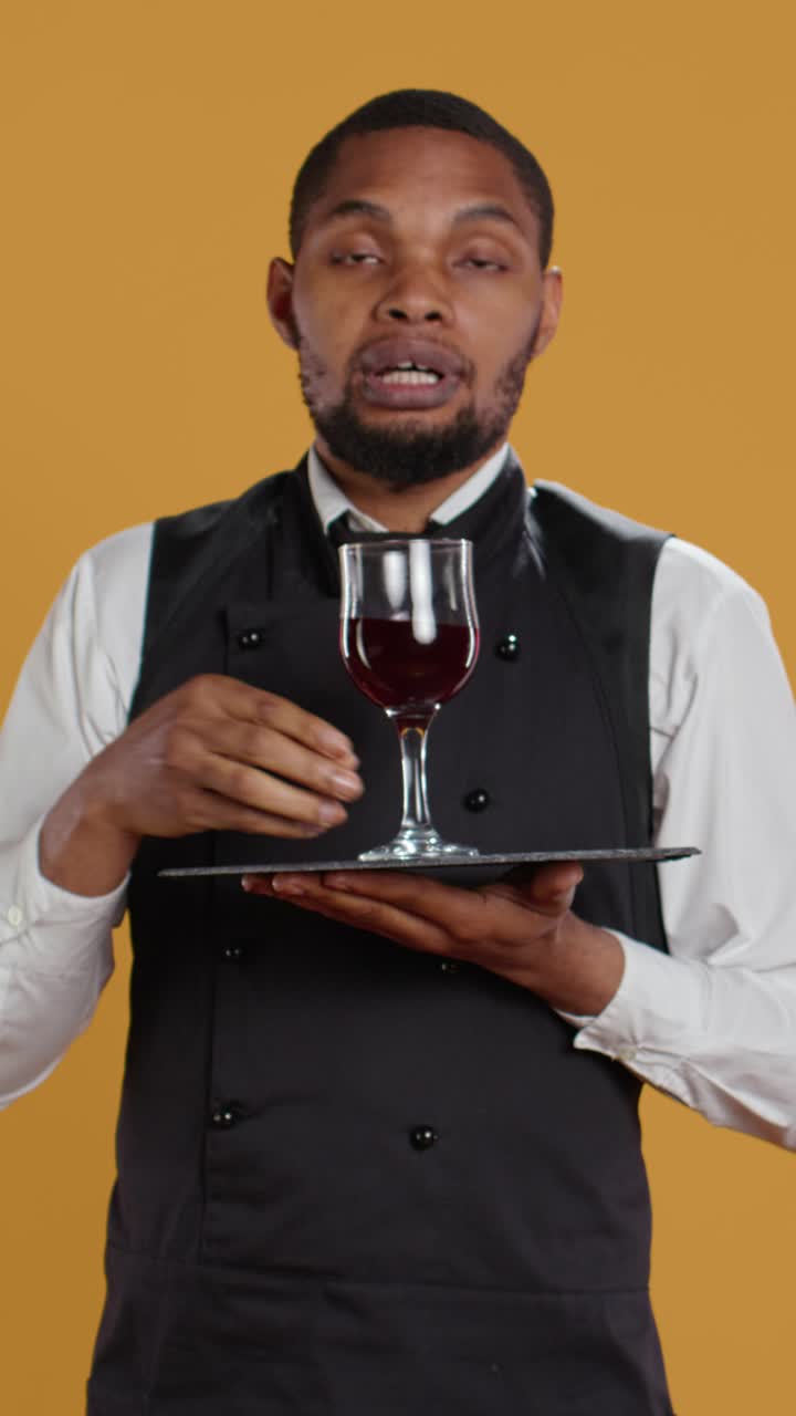 Professional Waiter Presenting Red Wine on a Tray