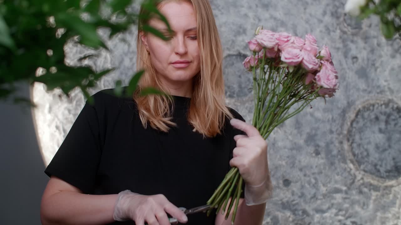 Florist cutting roses for a bouquet