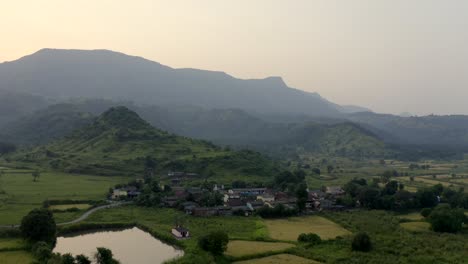 Tranquil-Scenery-With-Lush-Mountains-And-Green-Fields-In-The-Town-Of-Karjat-In-India---aerial-drone-shot