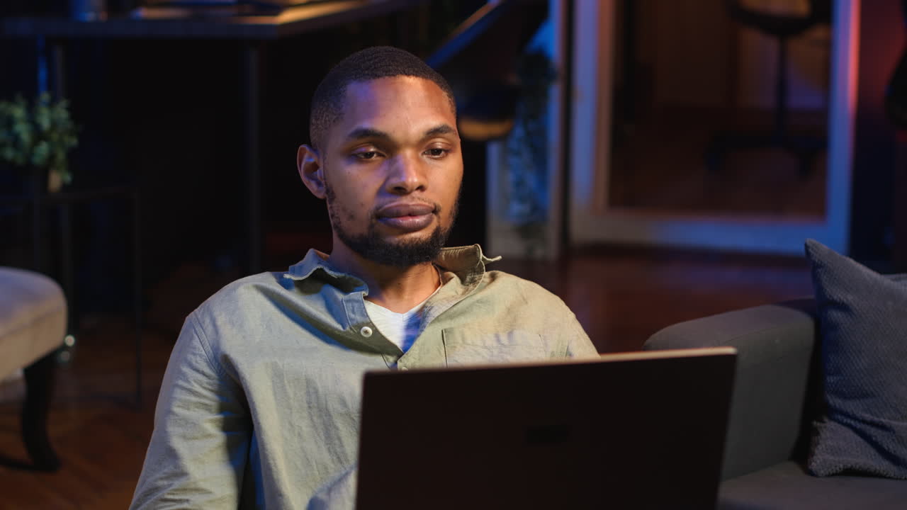 Vertical Video Black male freelancer taking online course to learn new skills from home