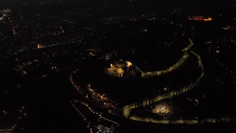 aerial rotating clockwise drone view of santuario madonna di lourdes - verona at night