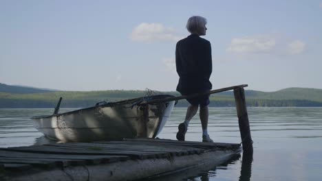 person sitting on a dock, lake view