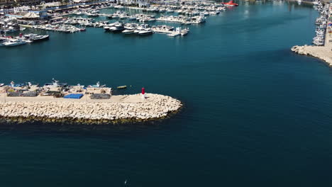 a drone reveals an aerial cityscape of estepona, spain from the harbor