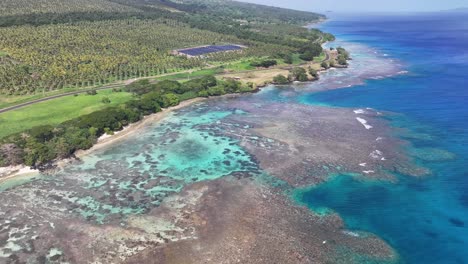 aerial view of coastal solar panel plant near garden island of taveuni, north of fiji.