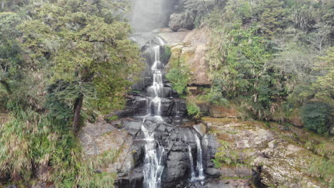 A-drone-shot-of-a-waterfall-in-Sun-Link-Sea,-Taiwan