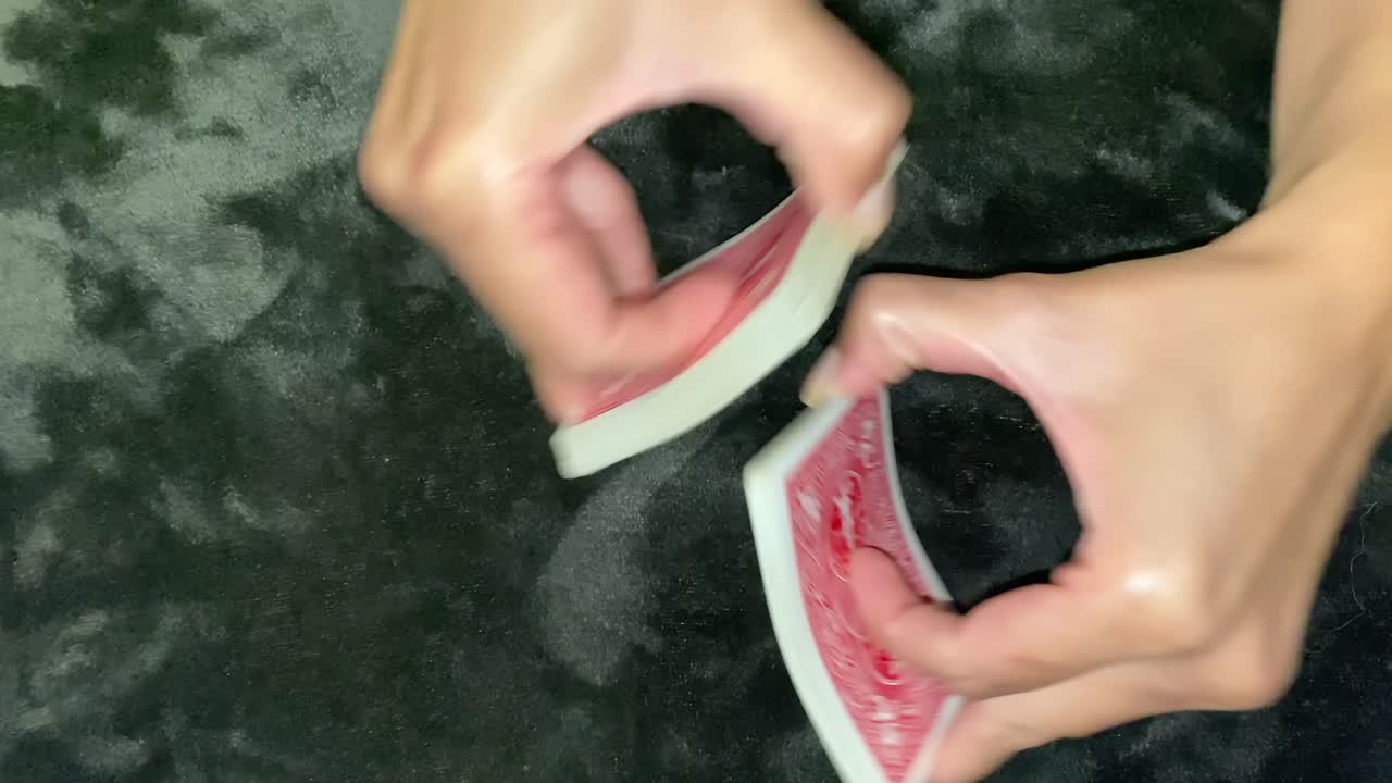 female hands shuffling a deck of cards gambling trick game close up
