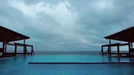 time-lapse of rain hitting a swimming pool in a holiday resort