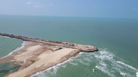 panoramic aerial drone shot of dhanushkodi, highlighting the final road of india surrounded by endless waters.