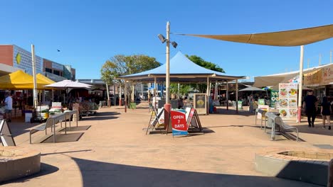 outdoor market with shoppers and vendors