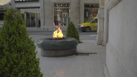 eternal flame in sarajevo, bosnia and herzegovina. foreground wipe reveal the burning fire.