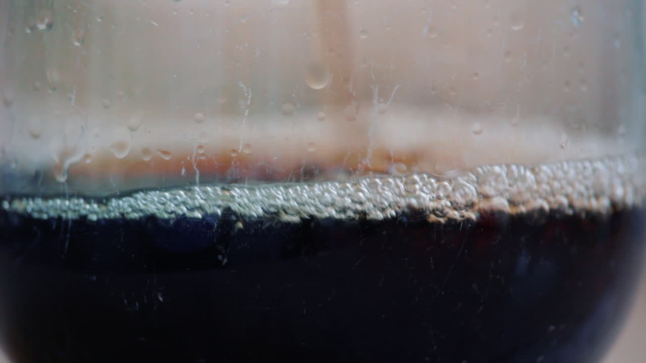 Cola Carbonated Drink Pouring In Transparent Glass