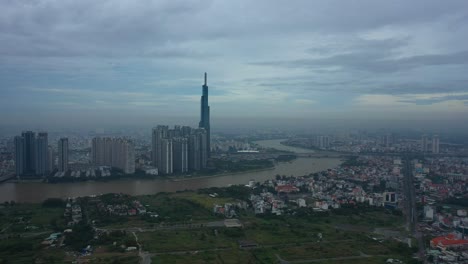 Long-Fly-in-towards-river-and-modern-city-development-with-high-rise-towers-in-early-morning