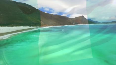 digital composition of nigeria flag waving against aerial view of waves in the sea