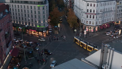 Aerial-view-of-cars-and-trams-driving-through-street-intersection-in-broader-city-centre.-Transport-in-city.-Berlin,-Germany