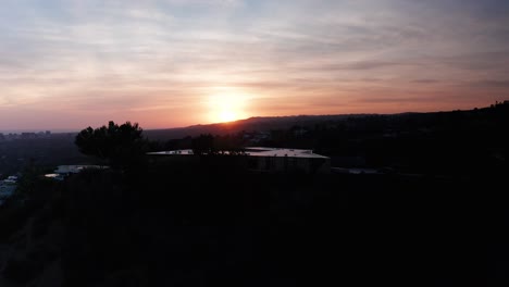 rising aerial shot of beverly hills hillside during sunset