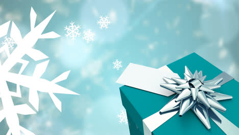 animación de la caída de copos de nieve sobre el regalo de navidad y
