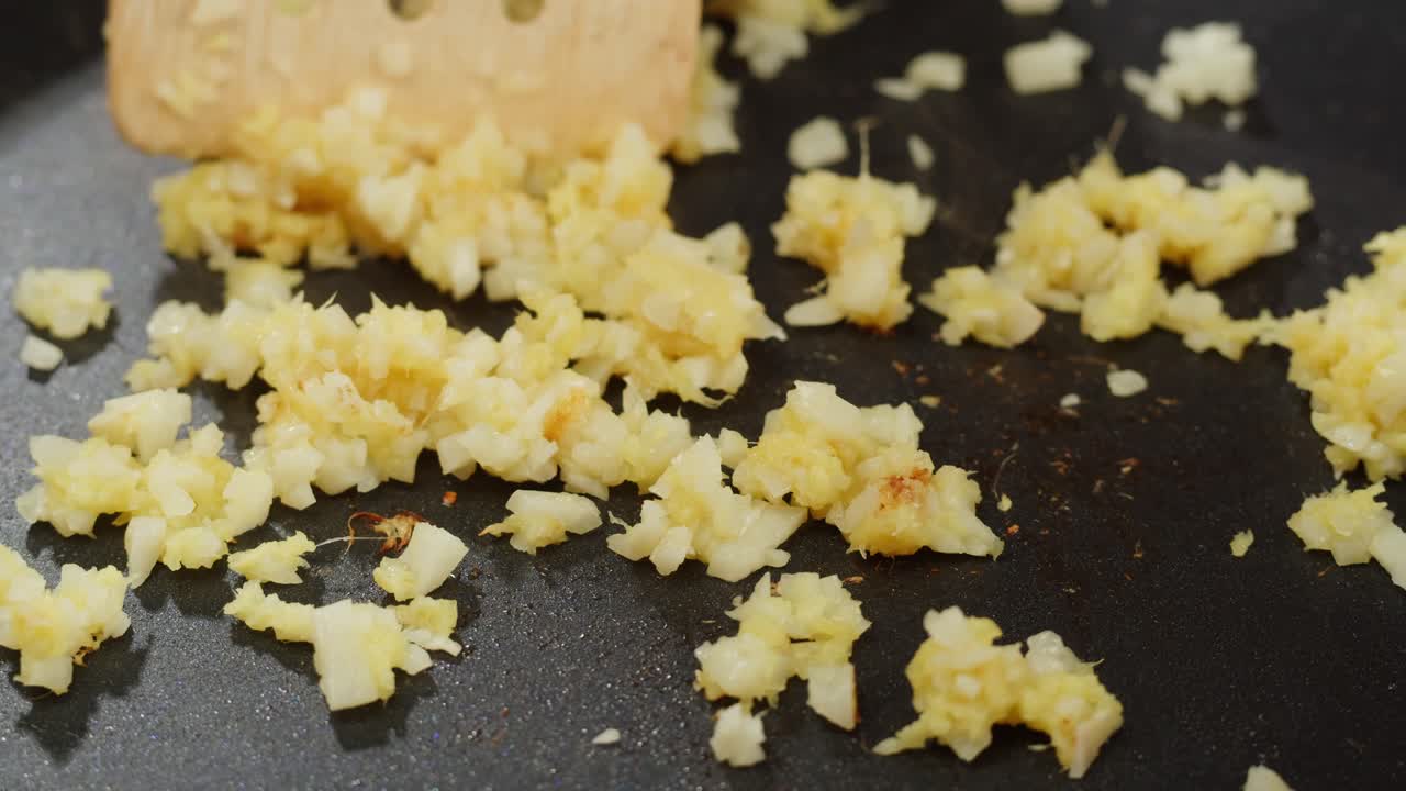 Peeled and Finely Chopped Ginger or garlic Root, Diced ginger on a wooden cutting board prepared for stew grill