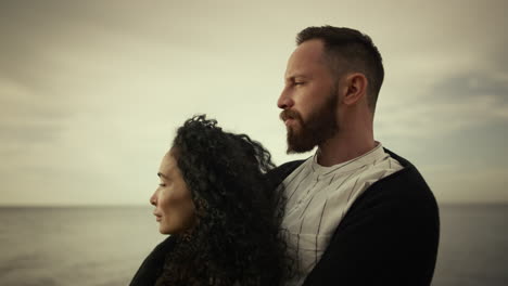 couple standing sea beach on vacation. multiethnic lovers enjoying family trip.