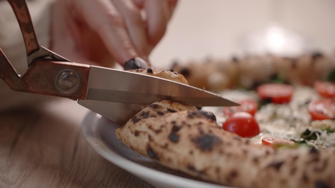 Woman Cutting a Delicious Homemade Pizza
