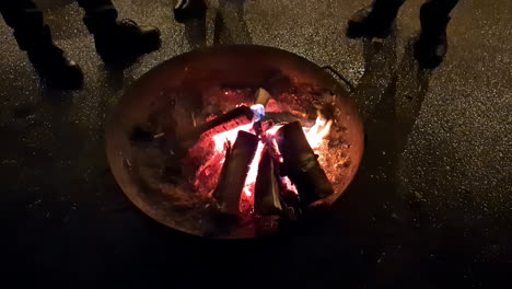 bonfire and people silhouettes standing nearby, slow motion view