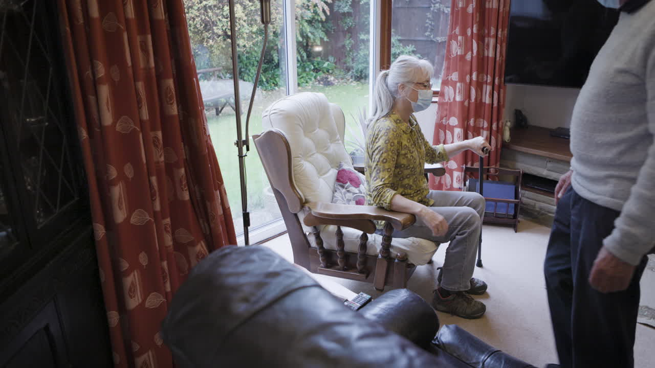 Elderly Couple Walking with Assistance at Home