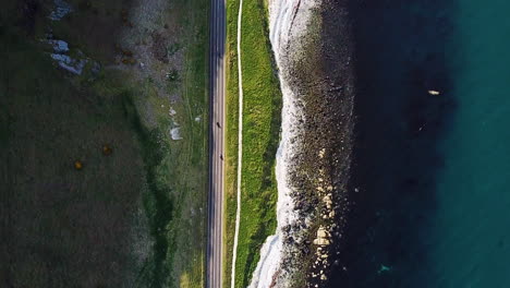 downward aerial view of road on coastline in northern ireland