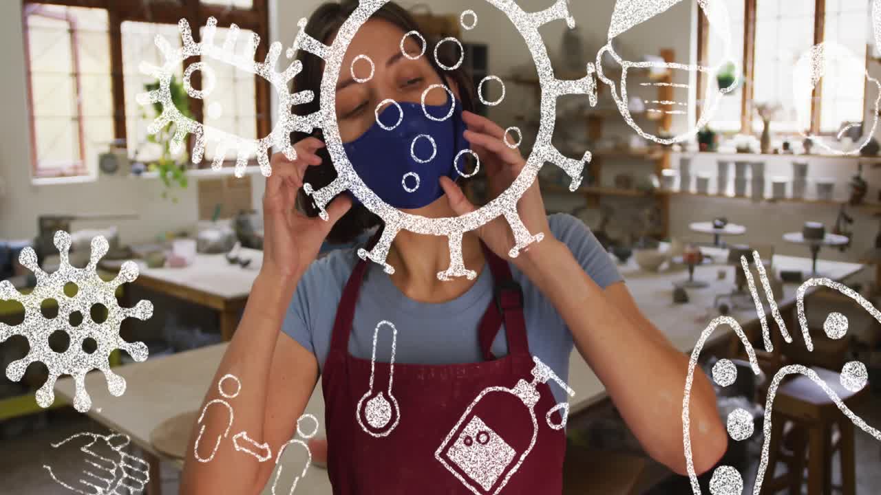 animación de iconos de virus sobre una mujer caucásica con máscara facial en un taller