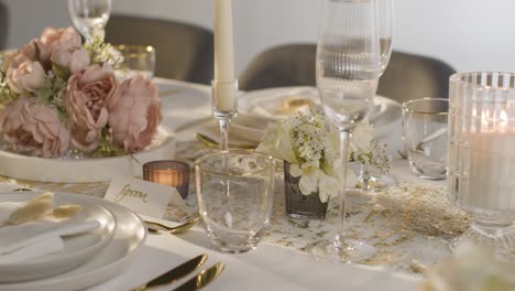 close up of table set for meal at wedding reception with place cards for bride and groom