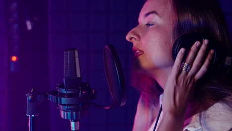 woman singing in recording studio