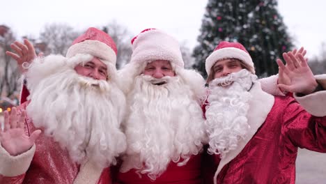 three santa clauses walk the streets of new york three santa clauses walk the streets of new york american santa at work they wave hello to the camera christmas mood concept