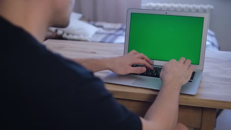the man works remotely. green laptop screen. selective soft focus. the concept of distance education. surfing the internet