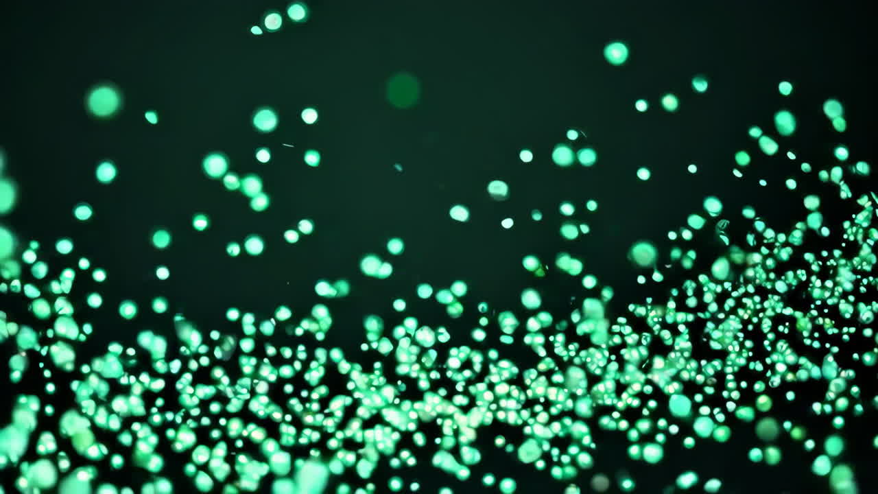 Teal Green Bokeh Particles on Black Background
