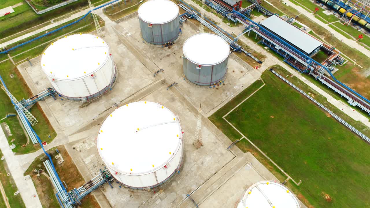 Aerial View White Round Reservoirs with Blue Pipelines