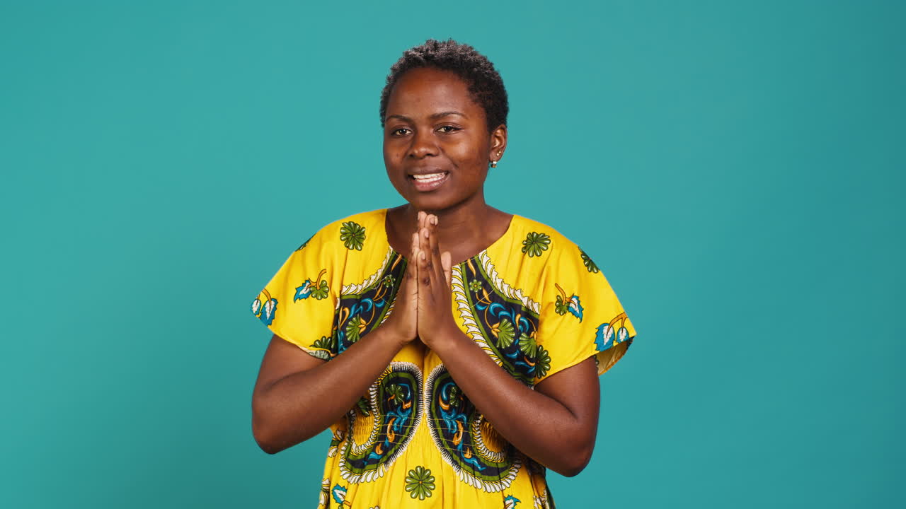 Confident optimistic woman holding hands in a prayer and talks to Jesus