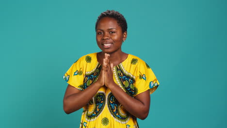 Confident-optimistic-woman-holding-hands-in-a-prayer-and-talks-to-Jesus