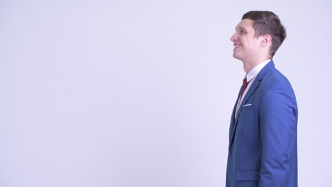 happy young handsome businessman in suit