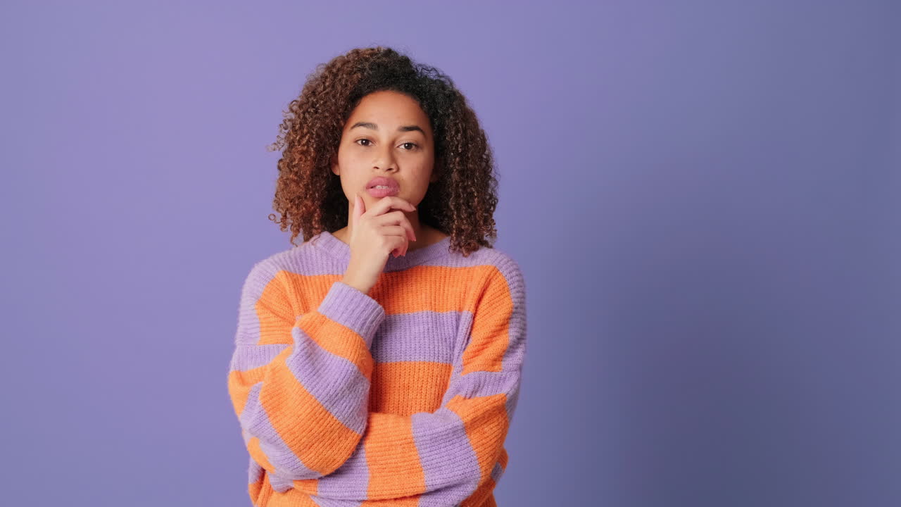 Thoughtful Young Woman Ponders and Then Smiles