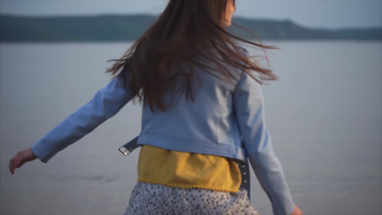 Woman by the lake at sunset