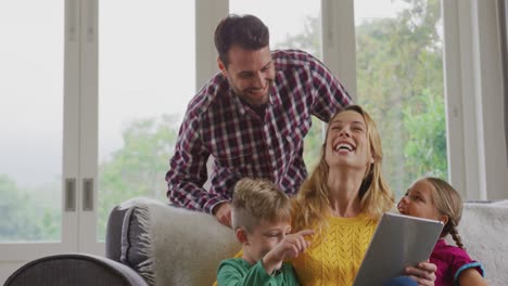 Family-using-digital-tablet-on-the-sofa-in-a-comfortable-home-4k