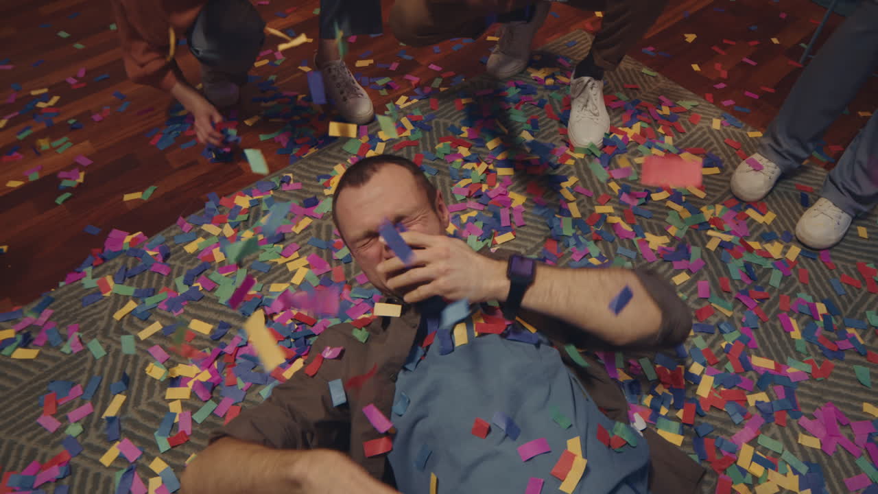 Party Man Lying on Floor with Confetti