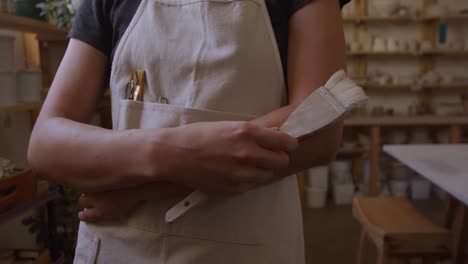 young female potter working in her studio