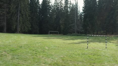 football soccer posts in forest clearing, remote mountainside sport scene