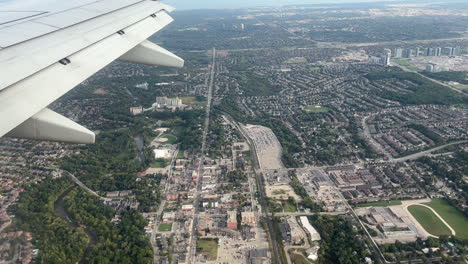 view of toronto before landing. passenger looking out of airplane window. real time