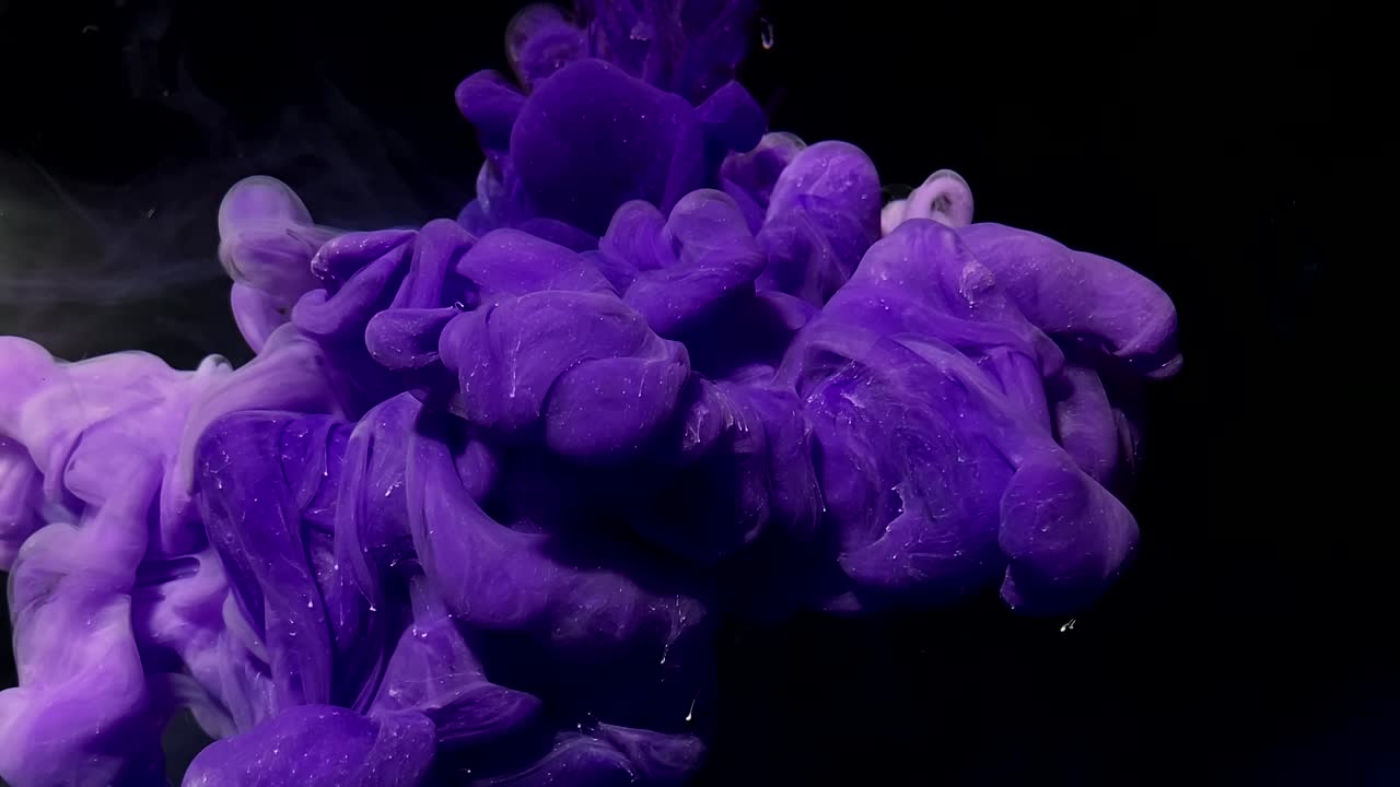 Blue planet earth from space. Violet and white watercolor ink in water on a black background.