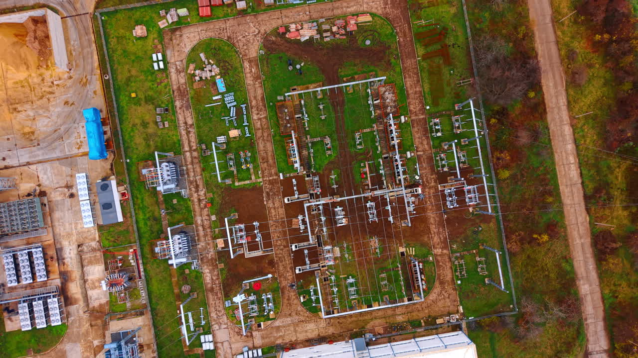 Site displays piping layout. A construction site has extensive piping, equipment, and open land ready for future development