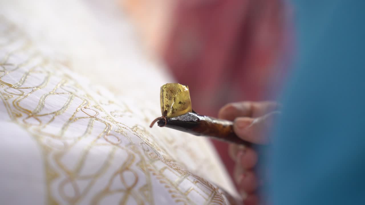 The technique of making hand-drawn batik using a canting tool. This craftsman is making batik typical of Giriloyo Bantul Yogyakarta.