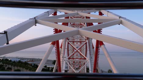 ferris wheel rotates against the sky in summer day